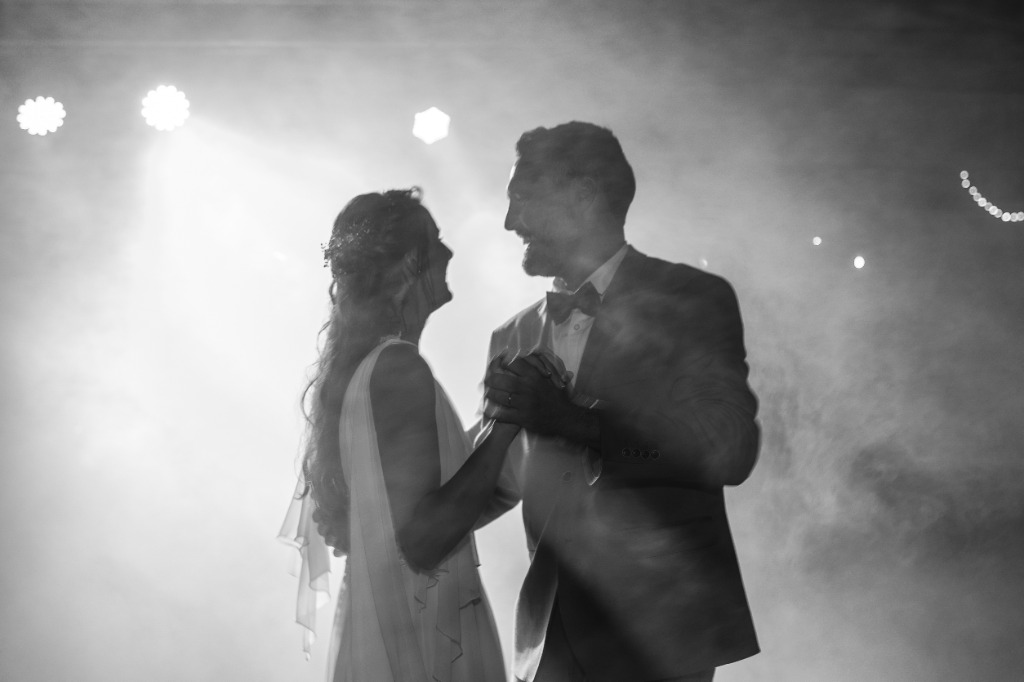 Pareja bailando en su boda bajo reflectores